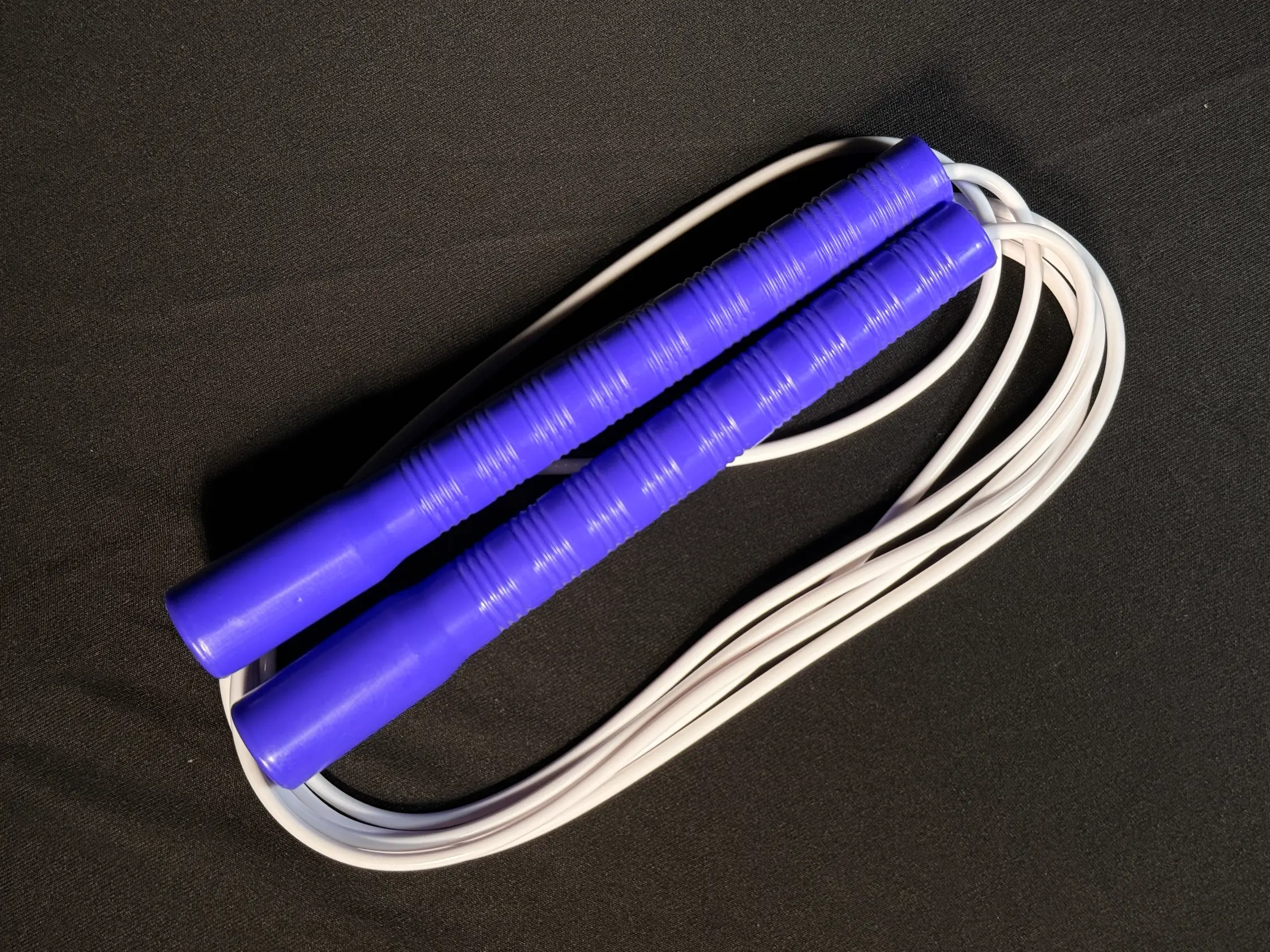 Basic long handle jump rope with lightweight plastic handles and PVC cord — ideal for beginner jumpers and casual skipping